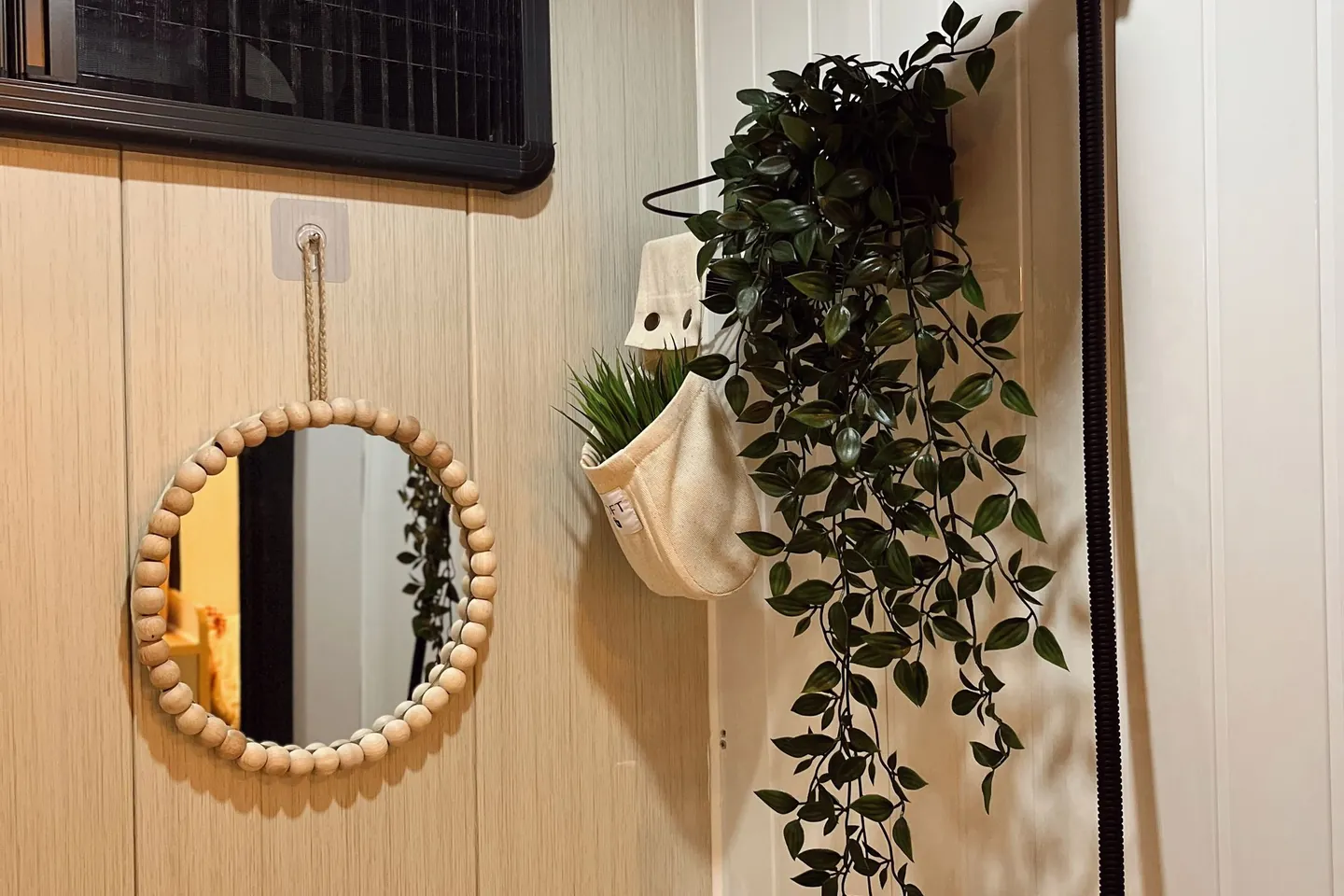 Bathroom mirror with greenery and warm decorative details.