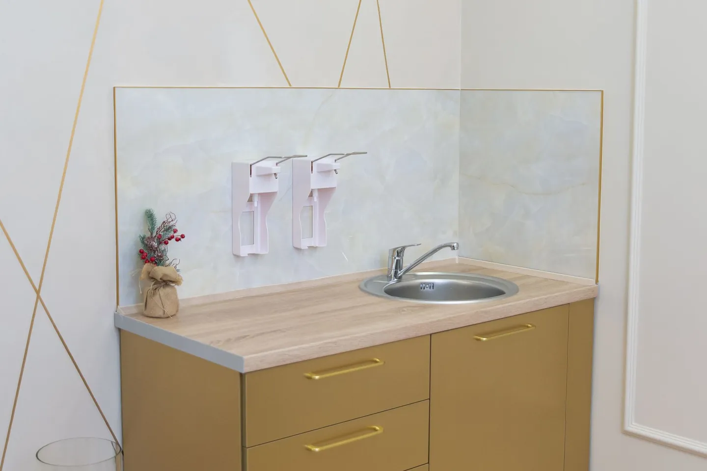 Bathroom sink with a compact storage cabinet beneath it.